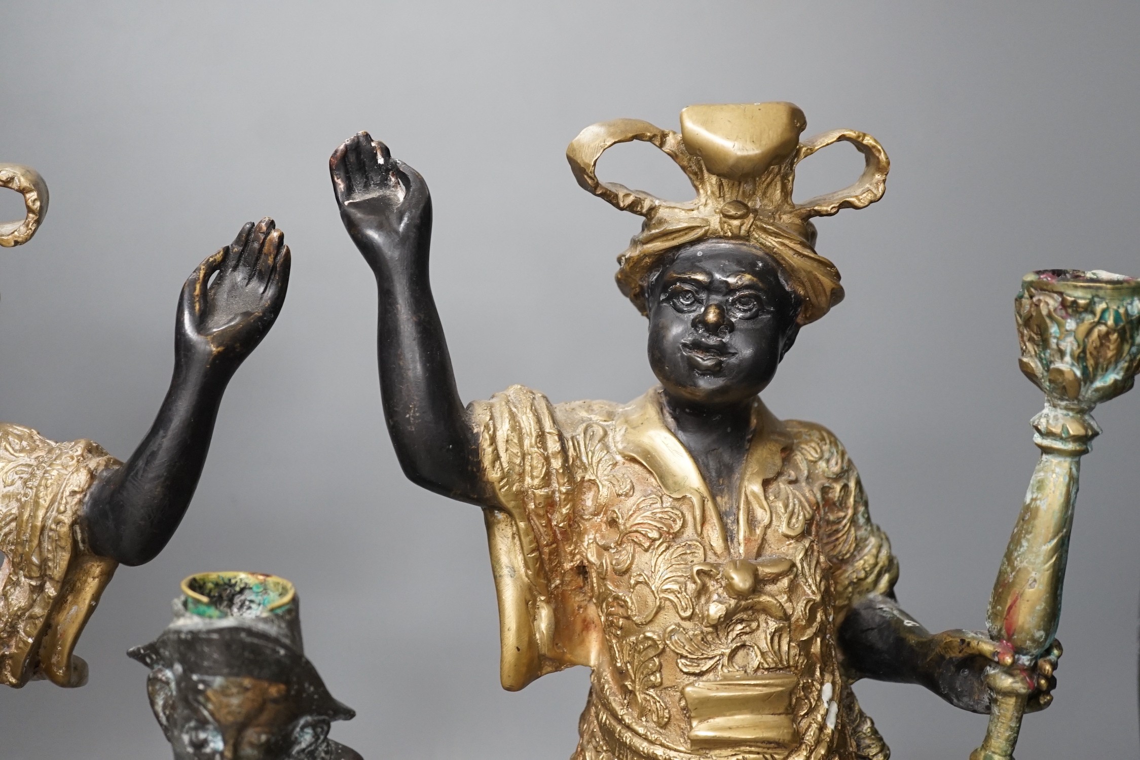 A pair of bronze blackamoor candlesticks and one other spelter figural candlestick, tallest 39cm